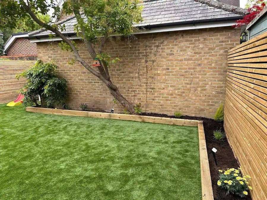 Artificial lawn with sleeper-edged border